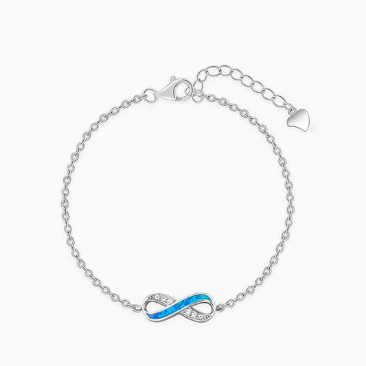Silver infinity bracelet for women with zircons and inlay.

