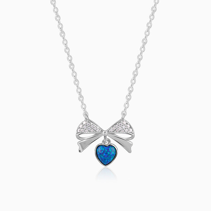 Silver bow necklace with blue opal heart and zircon accents